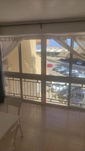 a room with a large window with a view of an airport at ESTUDIO DOS PLAYAS LA MANGA in Murcia +11 photos