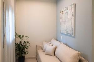 a living room with a couch and a plant at Syvota Gardens in Syvota