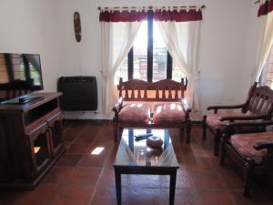 a living room with a couch and a piano at Chalet Individual Maiten 1 in Merlo