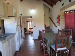 a kitchen and dining room with a table and chairs at Chalet Individual Maiten 1 in Merlo