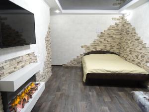 a bedroom with a bed and a stone staircase at Apart Perspektivna in Kropyvnytskyi