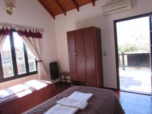 a bedroom with two beds and a large window at Chalet Individual Maiten 1 in Merlo