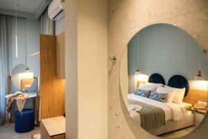 a bedroom with a bed with a large mirror at Syvota Gardens in Syvota