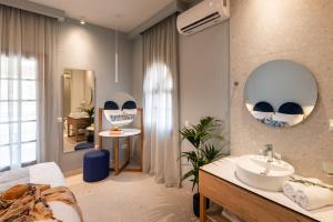 a bathroom with a sink and a mirror at Syvota Gardens in Syvota