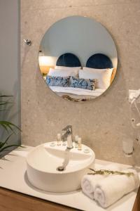 a bathroom with a sink and a mirror at Syvota Gardens in Syvota