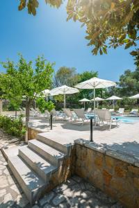 a set of stairs next to a pool with umbrellas at Syvota Gardens in Syvota +37 photos