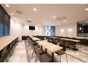 a conference room with tables and chairs and a screen at R&B Hotel Shin Osaka Kitaguchi - Vacation STAY 40553v in Osaka