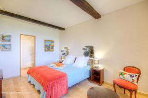 a bedroom with a bed and a chair at Castellu d'Orezza in Carcheto