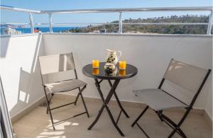 a small table and two chairs on a balcony at Apartmani Nela Sutomore in Sutomore