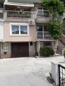 an apartment building with a garage and a balcony at Dona Apartments in Ohrid