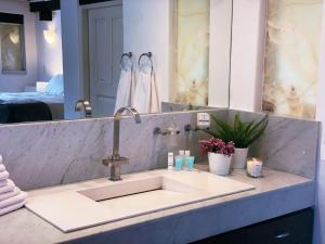 a bathroom counter with a sink and a mirror at Casa San Angel Inn Boutique charming house in Mexico City