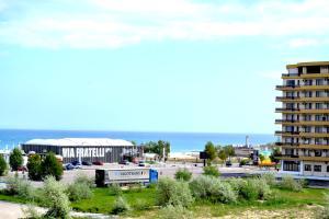 a view of a city with a building and the ocean at Luna Rossa Sumerland in Mamaia