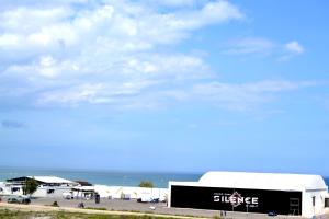 a building with a sign on it next to the ocean at Luna Rossa Sumerland in Mamaia +189 photos