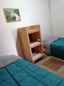 a room with two beds and a bunk bed at La Casa Blanca in San Pedro de Atacama