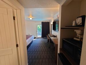 a hotel room with a bed and a television at Reagan Resorts Inn in Gatlinburg