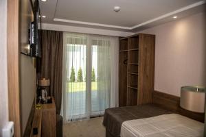 Postel nebo postele na pokoji v ubytování Arletti Hotel