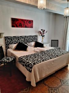 a bedroom with a large bed with red roses on the wall at Hotel Victoria in Florence