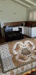 a room with a rug on the floor with a kitchen at Complejo Don Bosco in Tandil