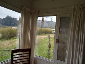 a window in a room with a view of a field at Complejo Don Bosco in Tandil