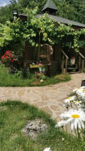 a garden with flowers in front of a building at Abant Korudam bungalov butik otel in Abant