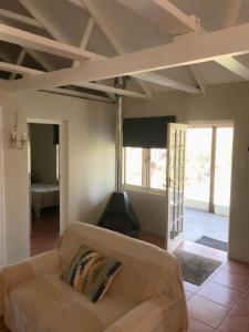 a living room with a couch and a fireplace at Boskloof Swemgat in Clanwilliam