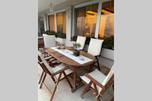 a wooden table and chairs on a patio at CASA LOUKAS in Nerotriviá