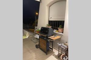 a balcony with a tv on a table with a desk at CASA LOUKAS in Nerotriviá