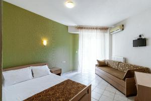 A bed or beds in a room at Stefanidis Platani Beach