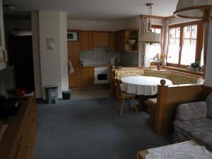 een keuken en woonkamer met een tafel en een bank bij Ferienwohnung Kaufmann in Schladming