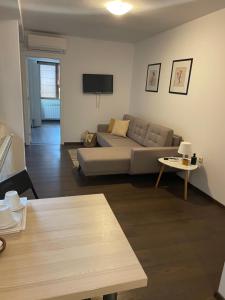 a living room with a couch and a table at Guest House Balchik Hills in Balchik