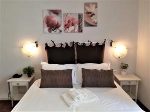a bedroom with a white bed with two night stands at Hotel Victoria in Florence +38 photos