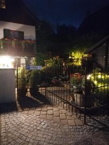 a wrought iron fence in front of a building at night at Wohnen im Ampertal in Grafrath in Grafrath