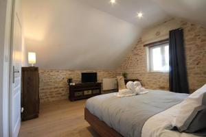 a bedroom with a bed and a television in a attic at Le Clos Ligérien in Nevers +15 photos