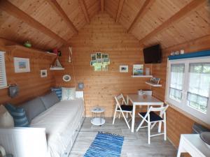 a living room with a couch and a table at Tinyhouse am Fluss in Otterndorf