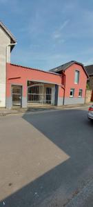 a red building with a car parked in front of it at Ganze Wohnung - schönes und helles Loft in Kreuzau in Kreuzau