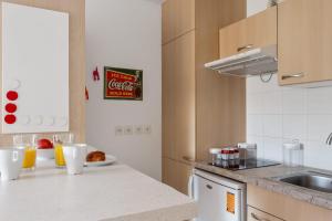 a kitchen with a counter top with a sink and a counter top at Appartement Californie - Welkeys in Nice