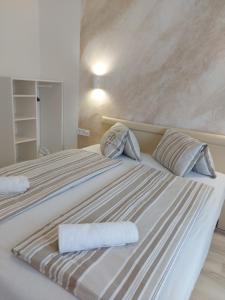 a bedroom with two beds with towels on them at Central Lux Apartments in Hajdúszoboszló
