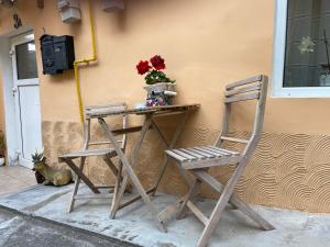 a table and two chairs next to a wall at Brick Wall in Sibiu