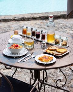 - une table avec des assiettes de nourriture et de boissons dans l'établissement Les Milles Roches, à Gordes