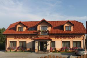 a building with a red tiled roof at Zajazd Skorpion B&B in Oświęcim