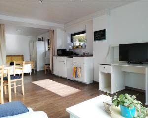 a living room with a kitchen and a table at Your Suite Runkel - Runkel, you're sweet! in Runkel