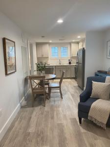 a kitchen and living room with a table and a couch at Harbourtown Suites in Plymouth