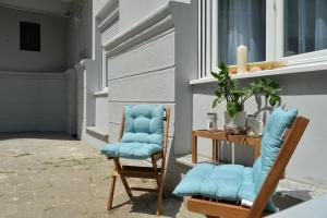 諾維薩德的住宿－Apartment Krins，门廊上摆放着两把蓝色椅子,配有桌子