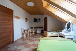 a living room with a bed and a table at Pokoje Gościnne Martynka in Białogóra