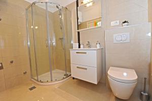 a bathroom with a shower and a toilet and a sink at Apartments Villa Violet in Zadar +31 photos