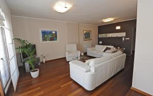 a living room with two white couches and a couch at Apartments Villa Violet in Zadar