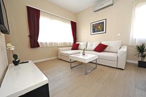a living room with a couch and a table at Apartments Villa Violet in Zadar