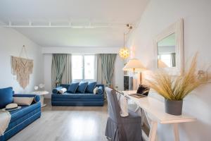 a living room with blue furniture and a blue couch at Rigas Boutique Hotel & Spa in Afitos