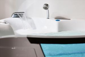 a bathroom sink with water running from a faucet at Nirome Luxury Suites in Adamantas