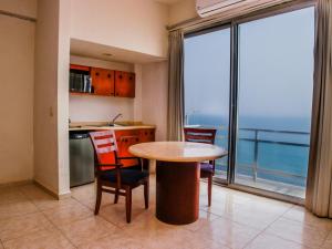 a kitchen with a table and chairs and a large window at Casabella Art Boutique Hotel in Veracruz